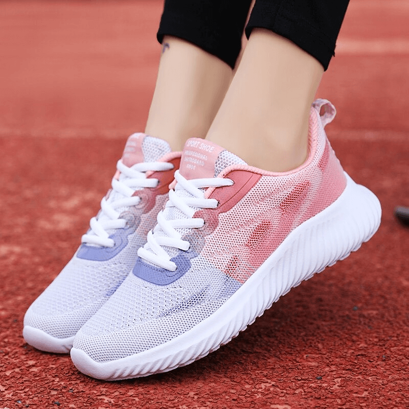 Women's breathable double color running shoes in pink and purple, perfect for fitness and comfort on the go. SF0254 model on red track.
